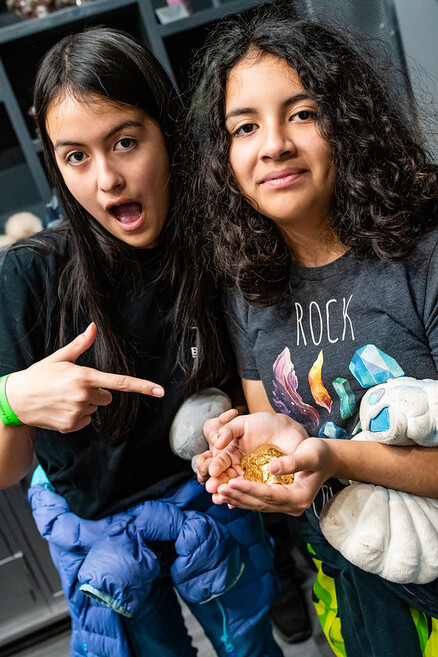 Two OGMS members holding a gold nugget at the NHMLAC